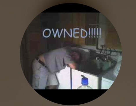 Tom passed out on a laundry tub after too many shots. Overlay: OWNED!!!!!